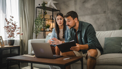 Fototapeta premium couple work from home on laptop and have video call consultation