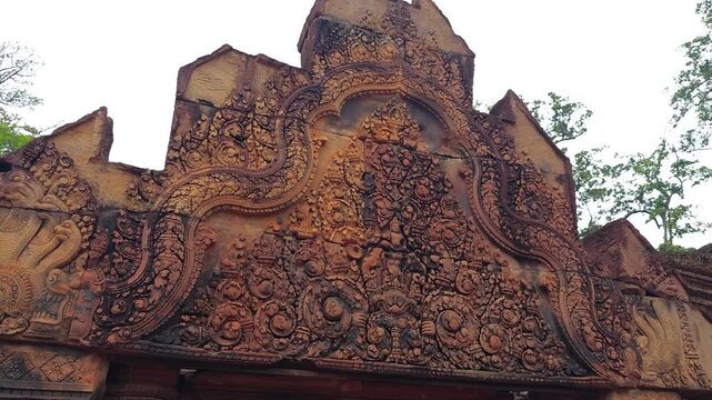 Move out from a close up of an ancient Angkorian temple doorway lintel at Banteay Srey, Siem Reap, Cambodia. This is an Angkorian site near Angkor Wat, Cambodia