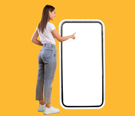 Full Body Length Back View Of Woman Using Big Smartphone With Blank White Screen And Touching...