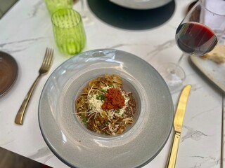 Spaghetti Carbonara with parmesan cheese on a restaurant table at Malta, Mdina