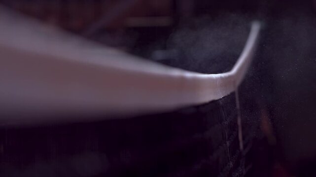 slow motion shot of a tennis ball flying over the net