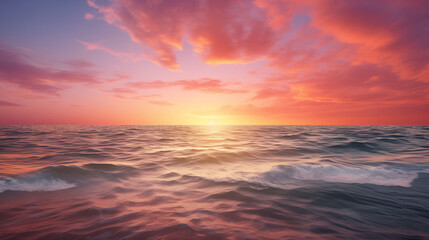 Stunning sunset over the ocean with vibrant pink and orange clouds reflecting on calm waves, creating a serene and peaceful seascape, perfect for nature and travel backgrounds