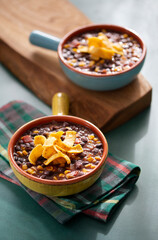 Two Crocks of Black Bean Soup Topped with Corn Chips, Chili Soup Comfort Food
