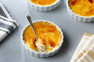 Cracked Sugar Creme Brulee Decadent Custard Dessert with spoon ready to share and eat