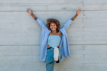 happy funny girl smiling on the street isolated on wall