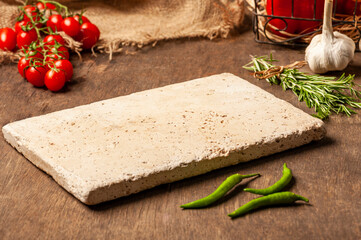 mockup image of a scene on a wooden table, an empty natural stone cutting, charcuterie, cheese...