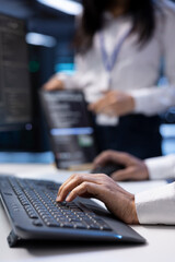 Supervisor checking event logs on computer to find out of order data center electronics root cause....