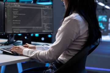 Computer scientist in data center using diagnostic tools and system monitoring software to identify...