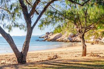 Picturesque golden sandy Alma Beach with granite boulders and turquoise water on Magnetic Island, Queensland, Australia.