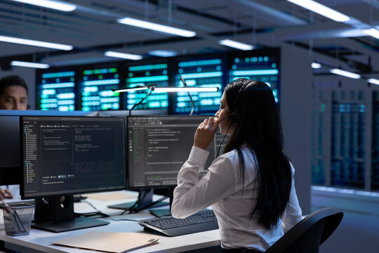 Team of specialists in data center call center responsible for providing logistics support to companies. Coworkers in server farm overseeing hardware systems and communicating with engineers