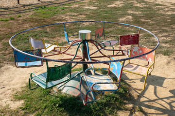 Rusty Vintage Merry-Go-Round in a Playground Evokes Nostalgic Childhood Memories