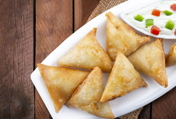 Isolated Potato Samosa Snacks on Wooden Background. Indian Ramadan Food, Pakistani Iftar Meal.