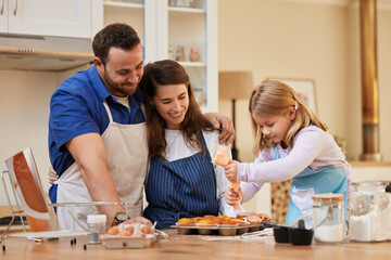 Parents, girl and baking in kitchen in home with batter ingredients for muffins, dessert and...