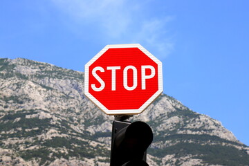 Road traffic sign STOP on a background of mountains in Croatia. Traffic stop sign
