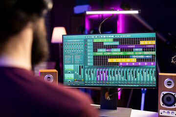 Sound engineer working with audio recordings on daw software interface, editing and adjusting...