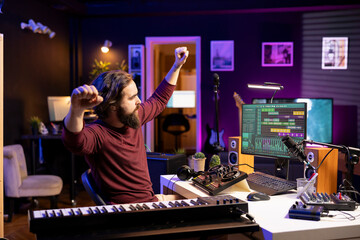 Audio engineer twisting pre amp knobs on mixing console in home studio, working with stereo gear for post production. Young songwriter recording soundtracks for music industry.