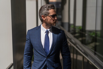 Business man in modern glass office. Portrait of handsome man CEO. Successful vision. New opportunities. Businessman office building. Successful business boss. Businessman in suit. Business ambition