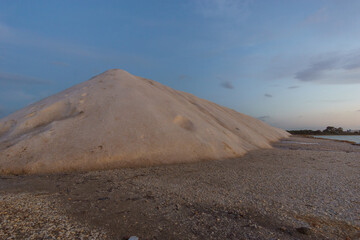 Blue hour during evening twilight after sunset at nature reserve Saline di Trapani with salt heap...