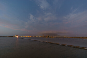 Dawn at nature reserve of Saline di Trapani with salt fields, Salt Museum and windmill with mountain Erice, Contrada Nubia, Sicily, Italy