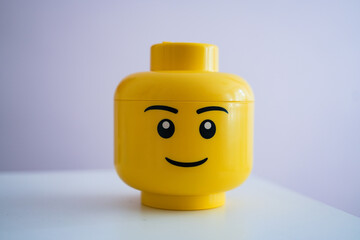 Naklejka premium Yellow Lego Head box on white background, 17 July 2024, Poland. 