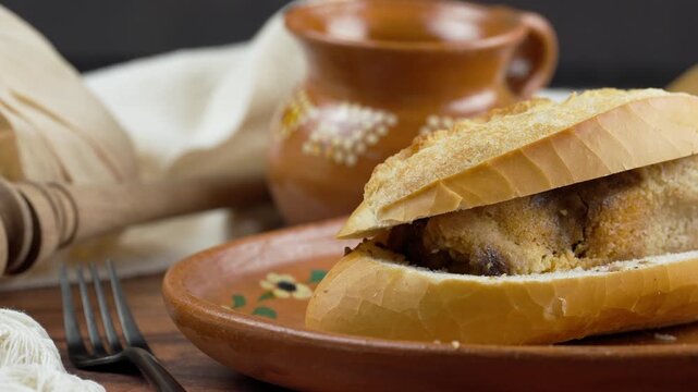 Bolillo with mexican mole tamal, Torta de tamal, Guajolota. Travel shot right Mexican food