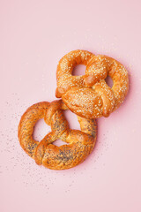 Delicious pretzels on pink background