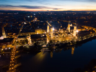 Night aerial view of Zaragoza with Cathedral-Basilica of Our Lady of Pillar on bank of Ebro river, Spain