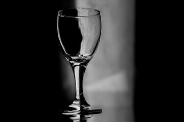 An empty wine glass on a dimly lit table