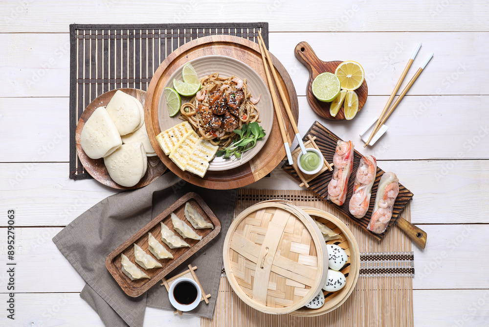 Wall mural Composition with different Chinese dishes and chopsticks on light wooden background