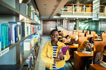 Portrait of a young African American female student in college library