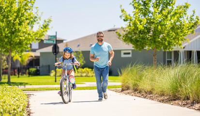 father and son promenade. father and son in fatherhood. fatherhood of father and son cycling at sunlit park. father and son navigate the winding paths together at fatherhood. Biking adventure