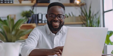 A person sitting at a desk with a laptop open, likely working or browsing