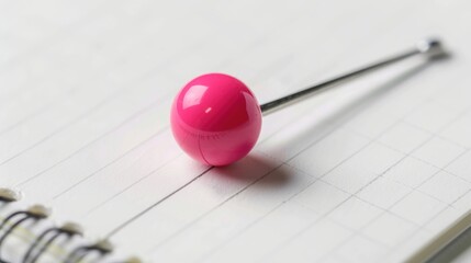 Pink pin on white notepad