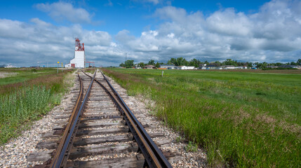 Railway tracks leading to a grain elevator in the village of Francis, Saskatchewan, Canada