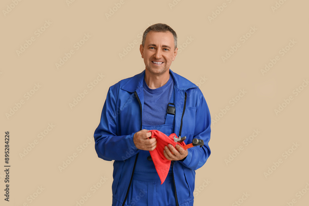 Canvas Prints Portrait of male mechanic with tools on beige background