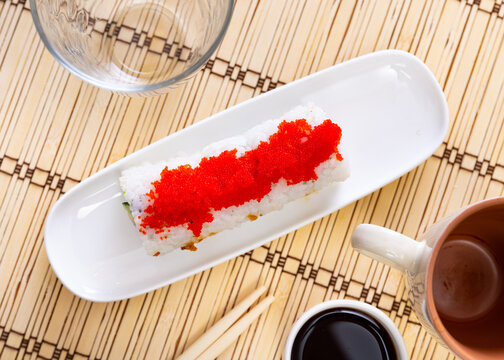 Appetizing Urumaki rolls with salmon, avocado, pepino and tobiko
