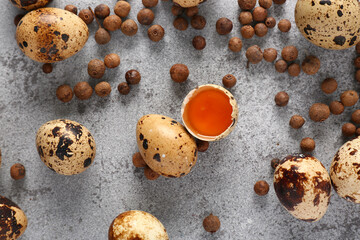Raw quail eggs and allspice on grunge background