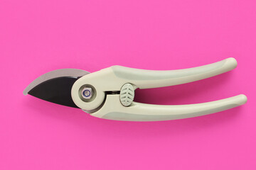 Gardening secateurs on pink background