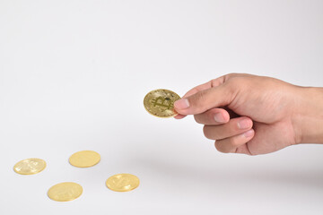 Man's hand holding bitcoin isolated on white background. Copy space. Crypto currency concept. Savings, investments concept. Modern digital method of payment. Clipping path