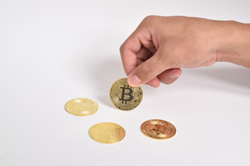 Man's hand holding bitcoin isolated on white background. Copy space. Crypto currency concept. Savings, investments concept. Modern digital method of payment. Clipping path