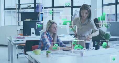 Image of ecology icons over diverse colleagues discussing work in office