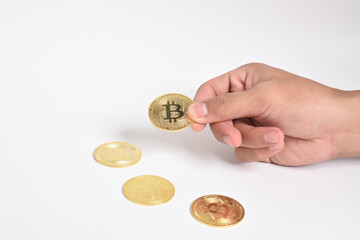 Man's hand holding bitcoin isolated on white background. Copy space. Crypto currency concept. Savings, investments concept. Modern digital method of payment. Clipping path