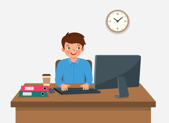 Young man working on computer at the desk in the office