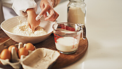 Parent, hands or kid with flour to bake in kitchen for growth development, helping or teaching in family home. Bowl closeup, chef or child learning pastry recipe for bonding, cooking food or dessert
