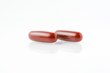 Two capsules fish oil,  Softgel Omega 3, Vitamin D,E,A. Supplement capsules isolated white...