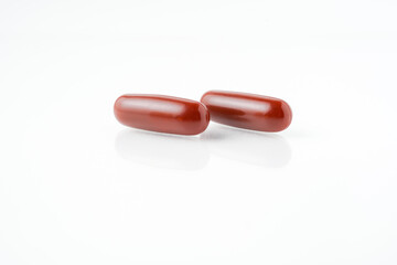 Two capsules fish oil,  Softgel Omega 3, Vitamin D,E,A. Supplement capsules isolated white background