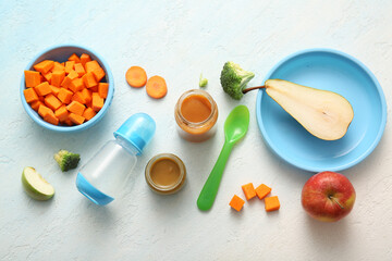 Composition with jars of healthy baby food, ingredients and bottle on light background