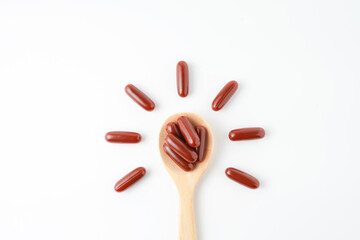 Vitamin capsules in a wooden spoon, soft gels, Fish oil capsules, omega 3, omega 9, vitamin D,...