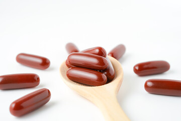 Vitamin capsules in a wooden spoon, soft gels, Fish oil capsules, omega 3, omega 9, vitamin D, vitamin E