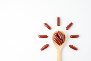Vitamin capsules in a wooden spoon, soft gels, Fish oil capsules, omega 3, omega 9, vitamin D,...